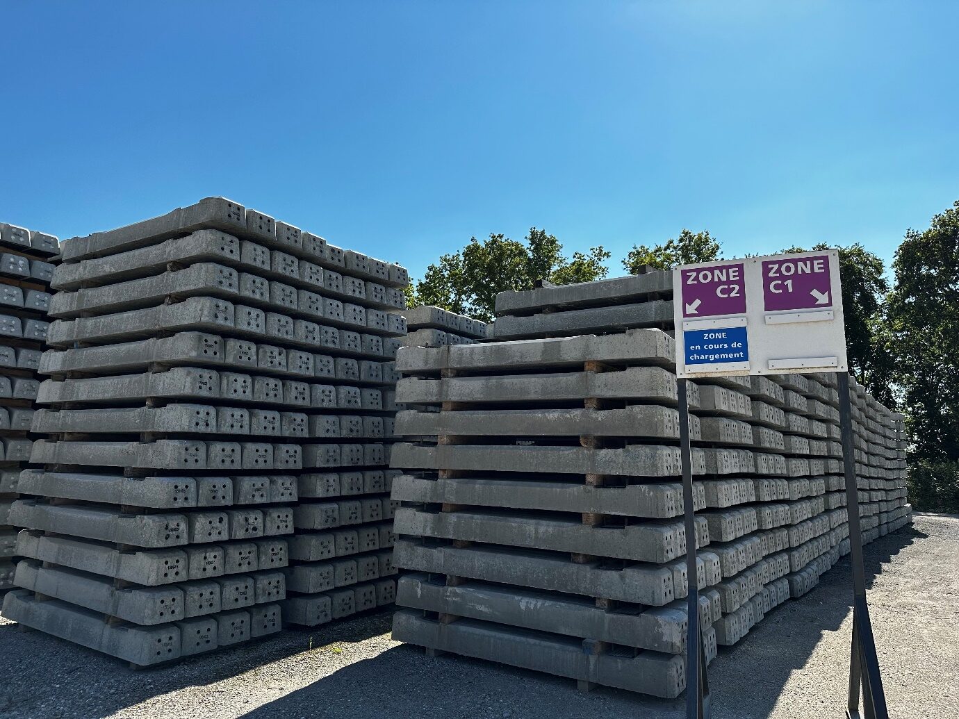 Stacks of Rail Europe Solutions reinforced concrete sleepers stored before shipment